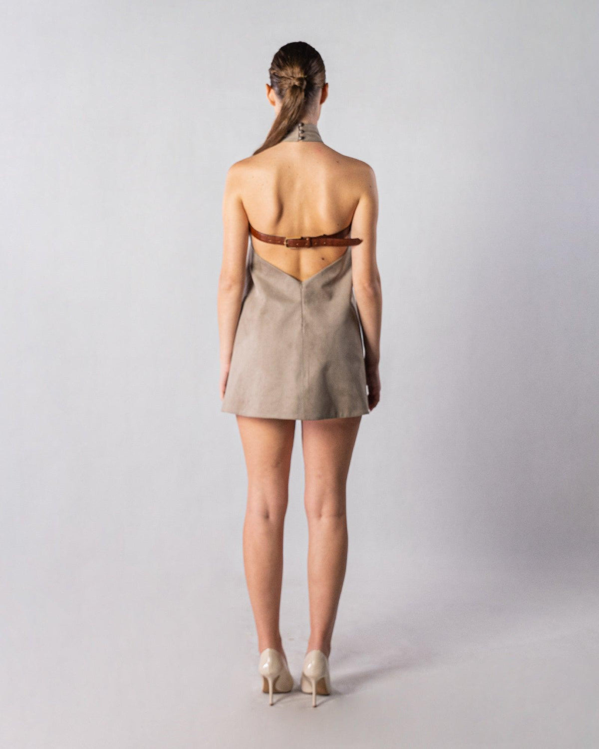 ALISADUDAJ CRAFT 06 grey faux-suede halter mini dress, back view showing open back with tan leather belt strap, faux suede