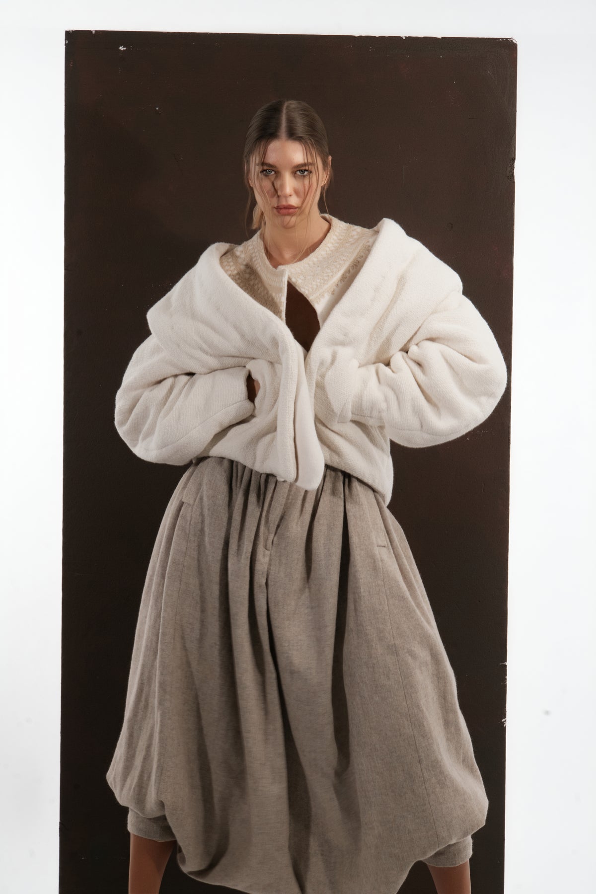 ALISADUDAJ ivory and beige wool cocoon jacket and draped trouser set, front view with jacket pulled off the shoulders, wool blend