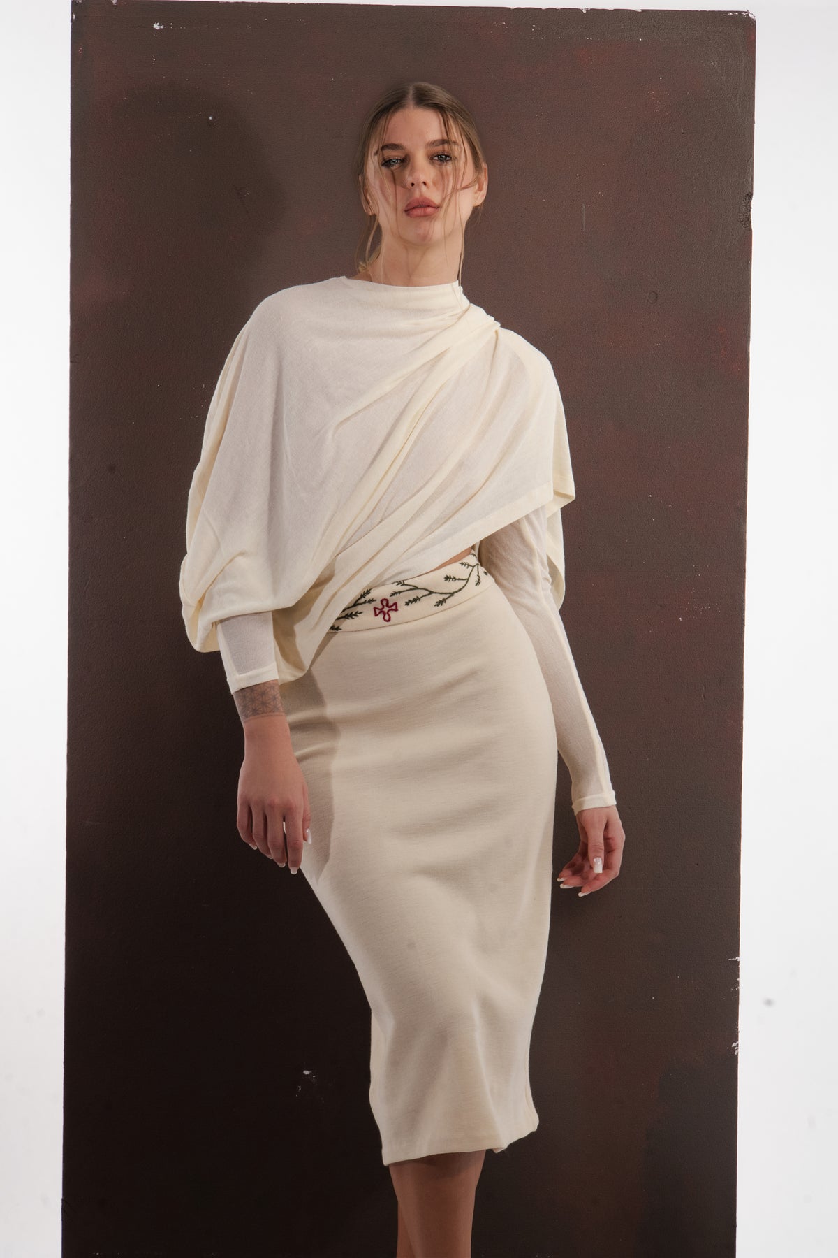 ALISADUDAJ ivory wool draped top and embroidered midi skirt set, front close-up of drape and floral waistband embroidery, wool blend