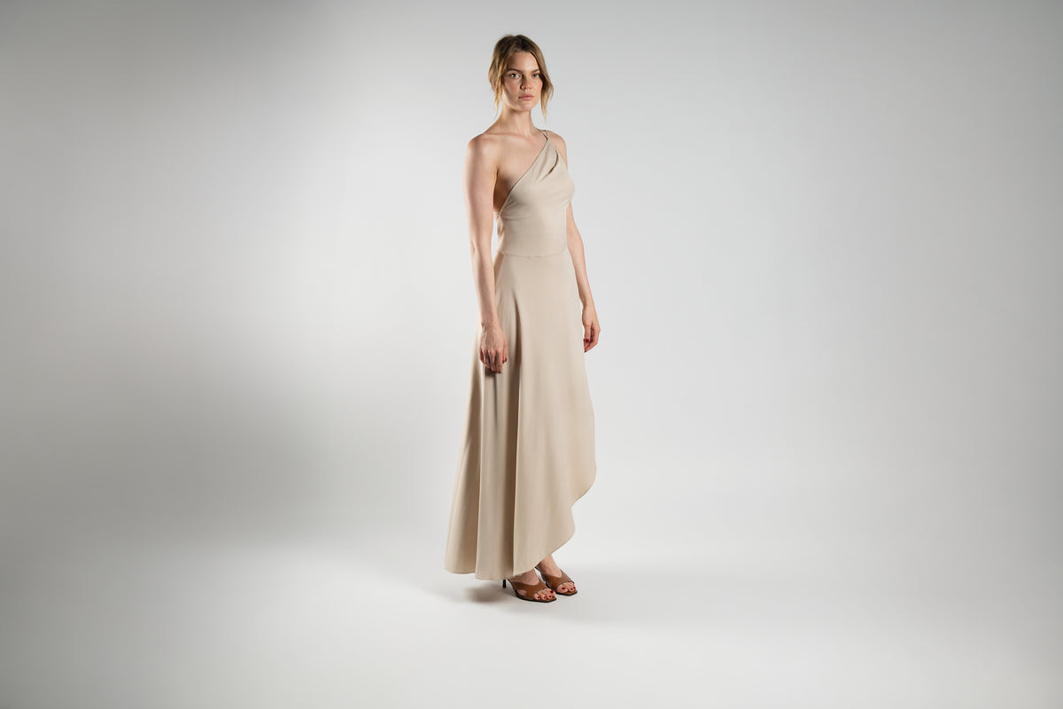 ALISADUDAJ beige cotton-twill one-shoulder maxi dress, three-quarter view showing draped asymmetric neckline and flowing skirt