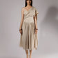 ALISADUDAJ beige linen and viscose one-shoulder draped dress, front view, full length, showing draped sash and gathered culotte skirt
