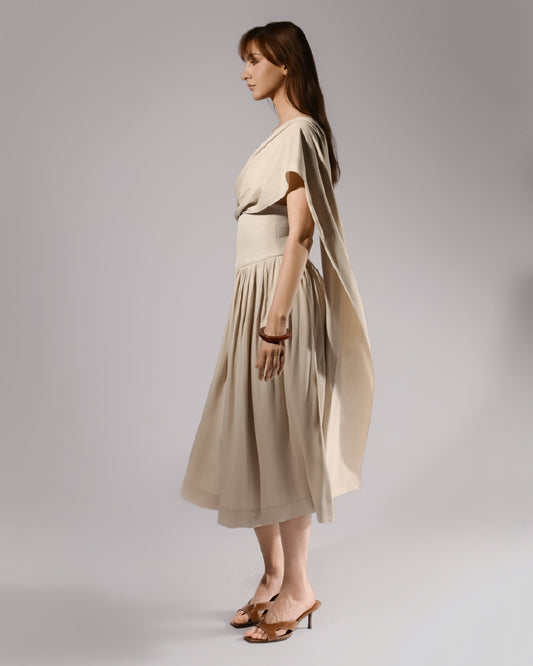 ALISADUDAJ beige linen and viscose one-shoulder draped dress, side profile showing trailing drape panel