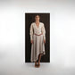 ALISADUDAJ beige wool asymmetric dress, front three-quarter view showing deep V neckline