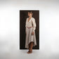 ALISADUDAJ beige wool asymmetric dress, side profile showing sleeve volume and asymmetric hem