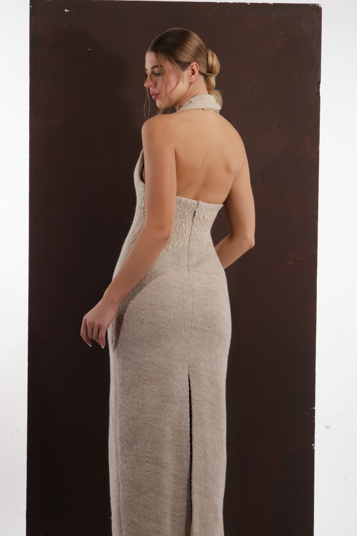 ALISADUDAJ beige wool halterneck column dress, back three-quarter view showing open back and centre slit