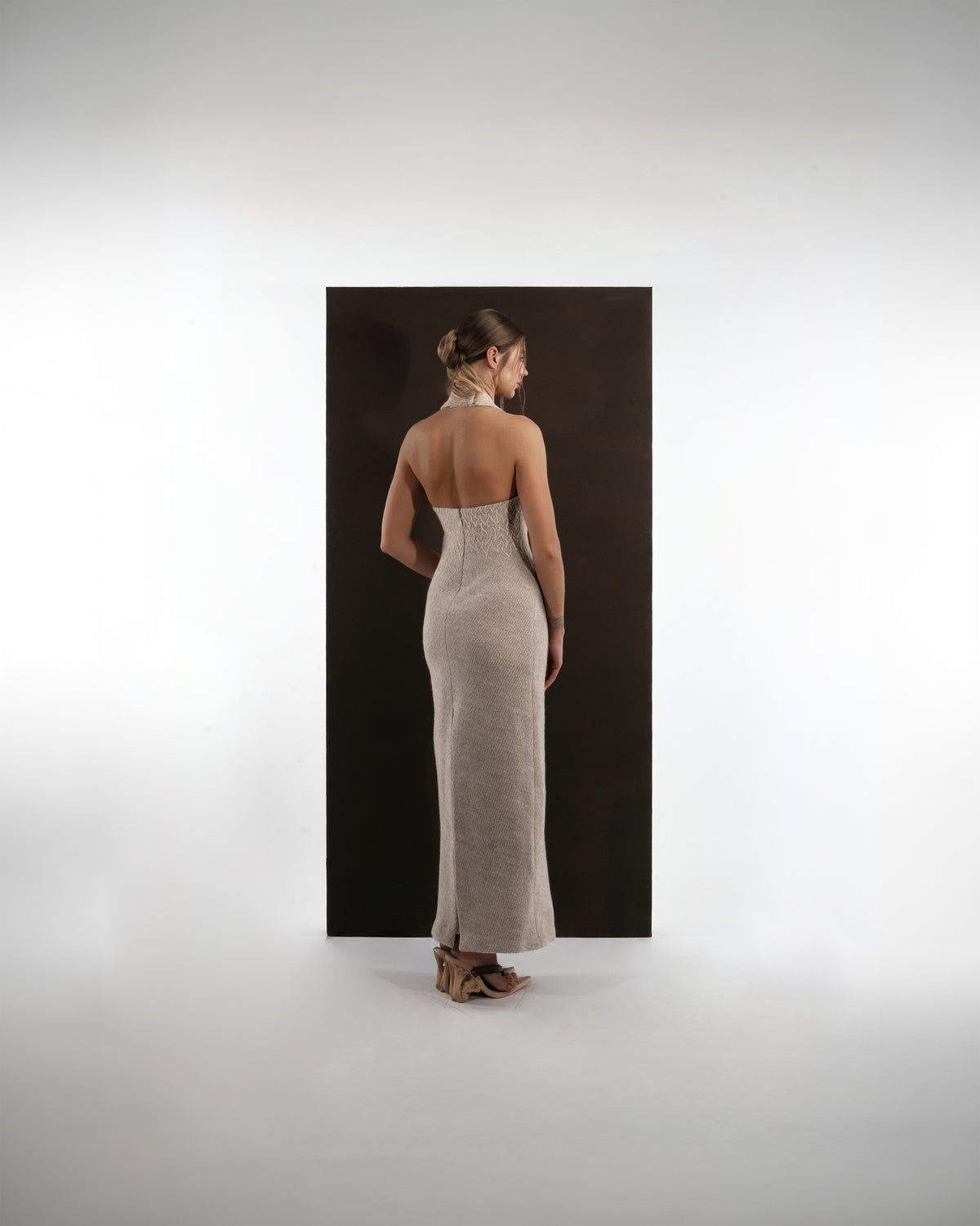 ALISADUDAJ beige wool halterneck column dress, back view showing open back and back slit