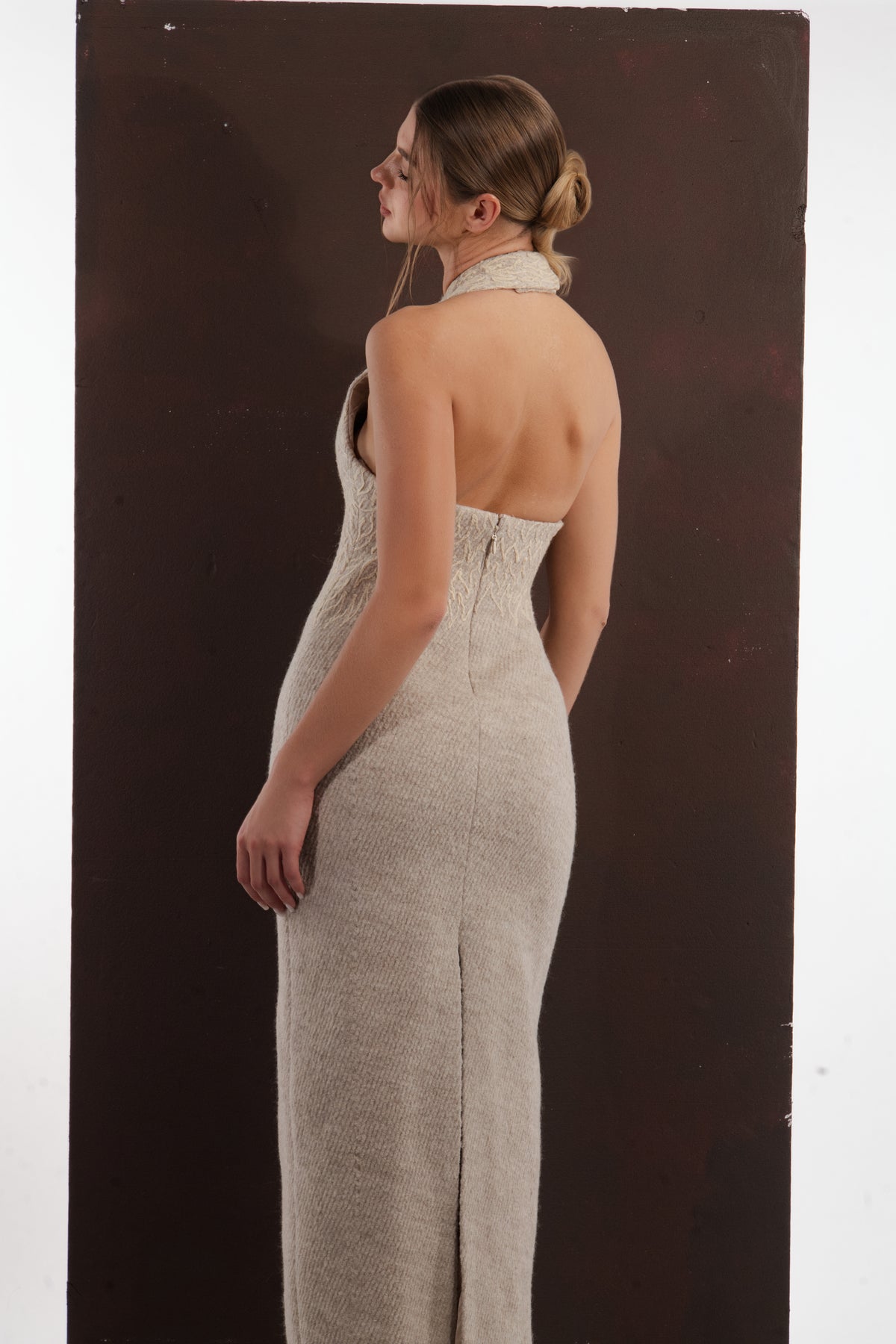ALISADUDAJ beige wool halterneck column dress, back close-up of open back, zip and skirt slit, wool blend