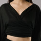 ALISADUDAJ black linen deep-V wrap top and midi skirt set, front close-up of crossover V neckline and tie-front wrap, linen