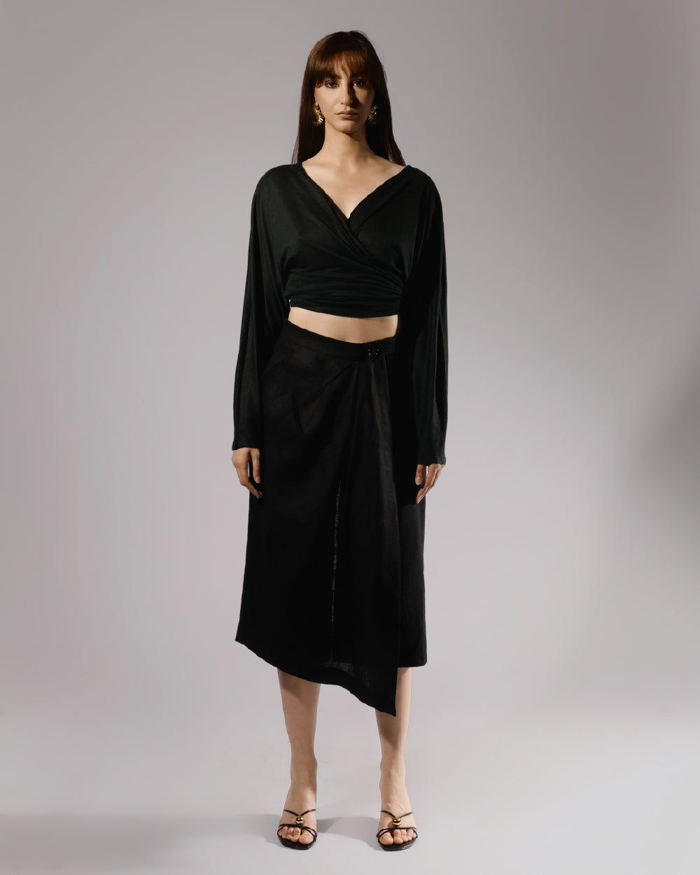 ALISADUDAJ black linen deep-V wrap top and midi skirt set, front view, full length, showing batwing sleeves and asymmetric wrap hem