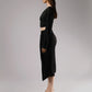 ALISADUDAJ black linen deep-V wrap top and midi skirt set, side profile showing draped sleeve and side slit
