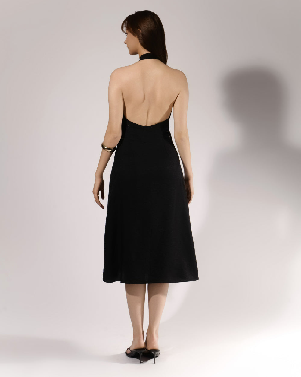 ALISADUDAJ black linen halter cut-out dress, back view showing open halter back and A-line midi skirt