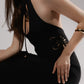 ALISADUDAJ black linen halter cut-out dress, side close-up of halter neckline and waist cut-out, linen