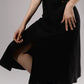 ALISADUDAJ black linen halter cut-out dress, close-up of A-line skirt and hem in motion