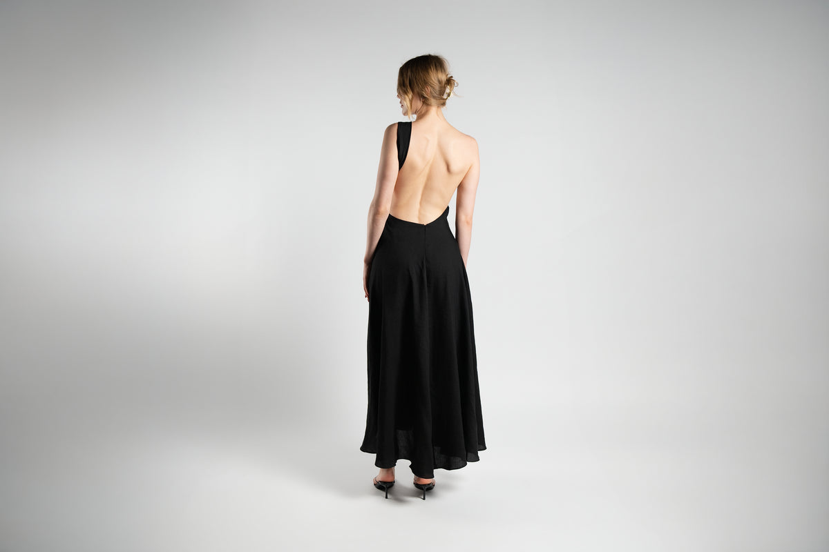 ALISADUDAJ black linen-silk one-shoulder dress, back view showing open back and flowing maxi skirt