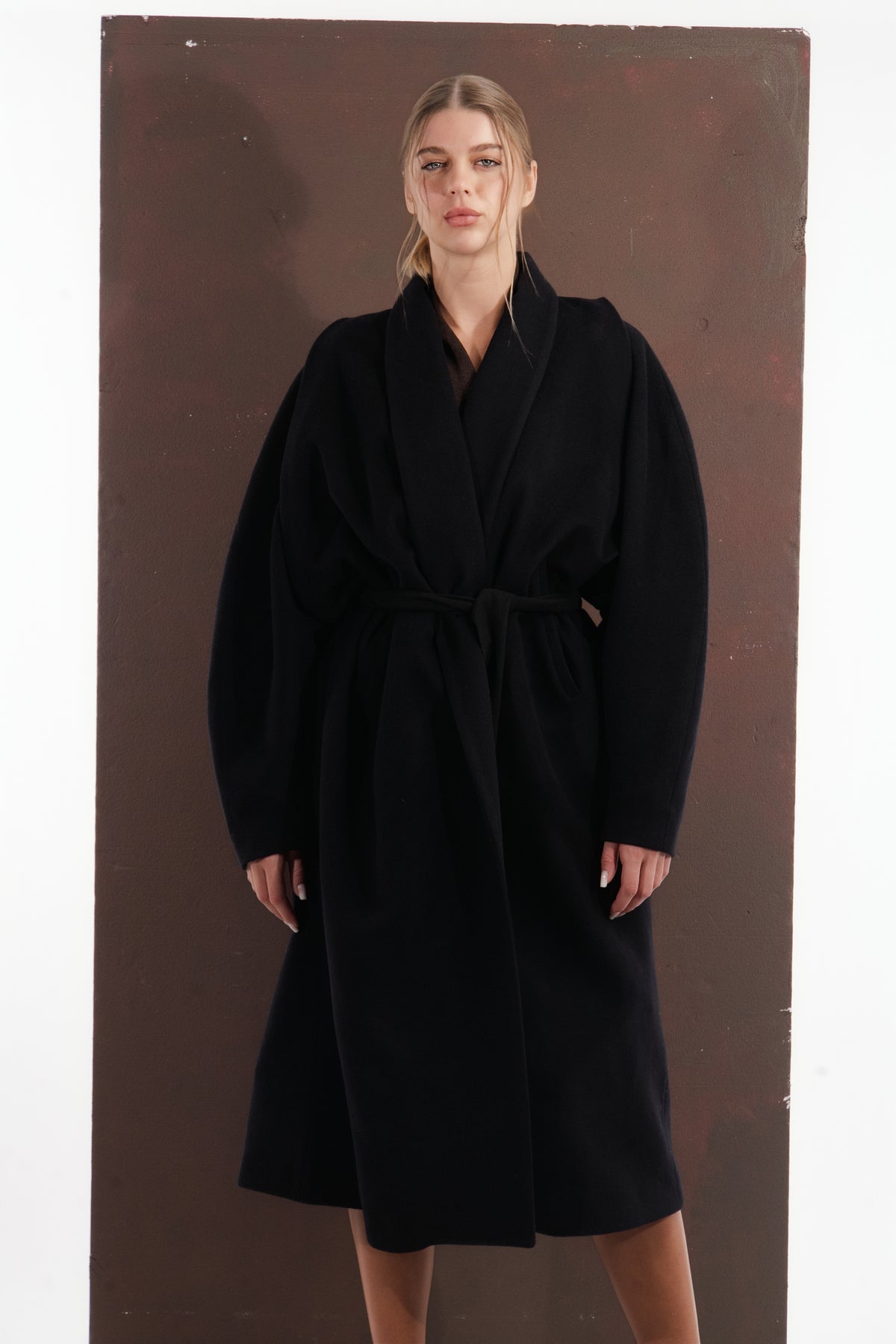 ALISADUDAJ black wool belted wrap coat, front view showing rounded sleeve volume and belted waist