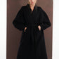 ALISADUDAJ black wool belted wrap coat, front view with hands in pockets showing shawl collar