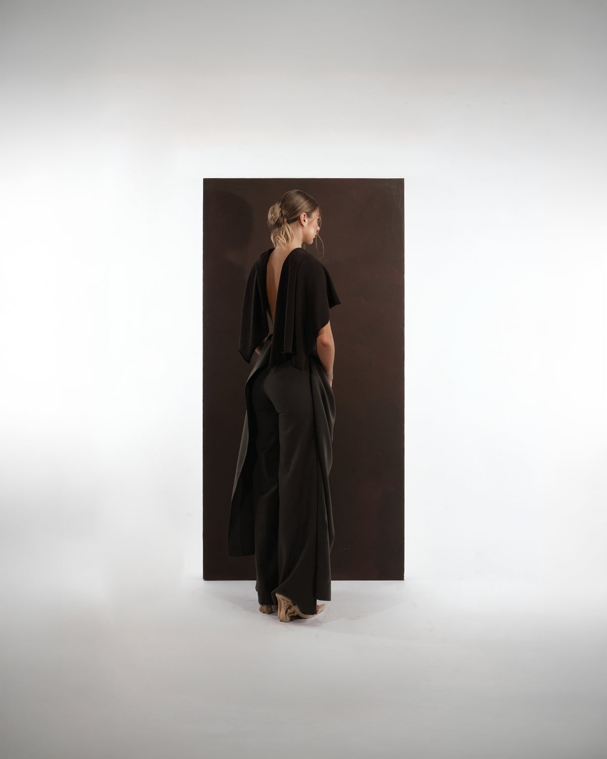 ALISADUDAJ black wool draped cowl top and trouser set, back view showing open back and trailing drape