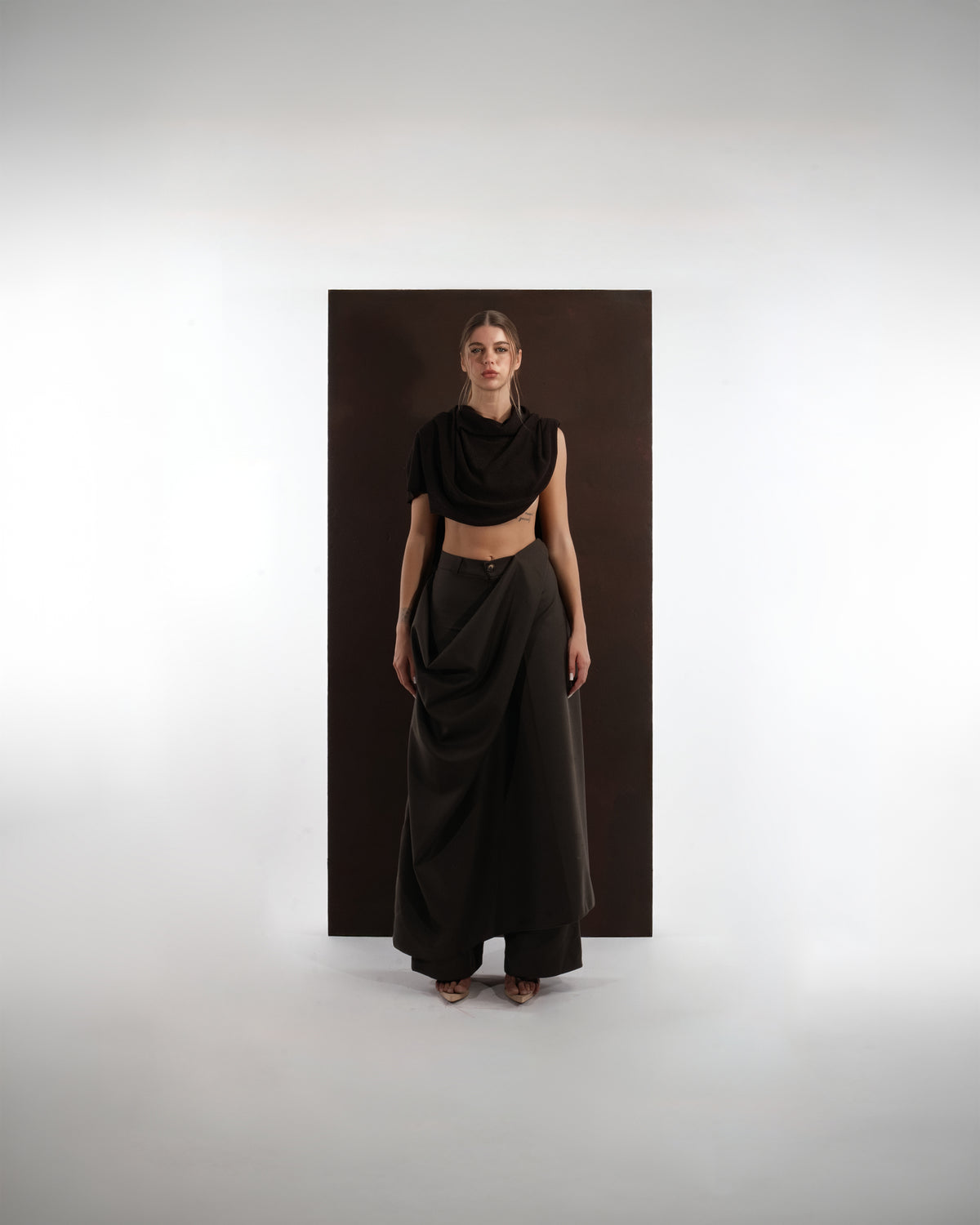 ALISADUDAJ black wool draped cowl top and draped trouser set, front view showing cropped cowl drape and waist panel