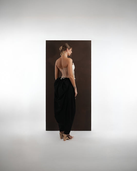 ALISADUDAJ black wool draped harem trousers, back view showing gathered drape and tapered ankle