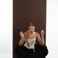 ALISADUDAJ black wool draped harem trousers, crouching view showing draped folds across the legs