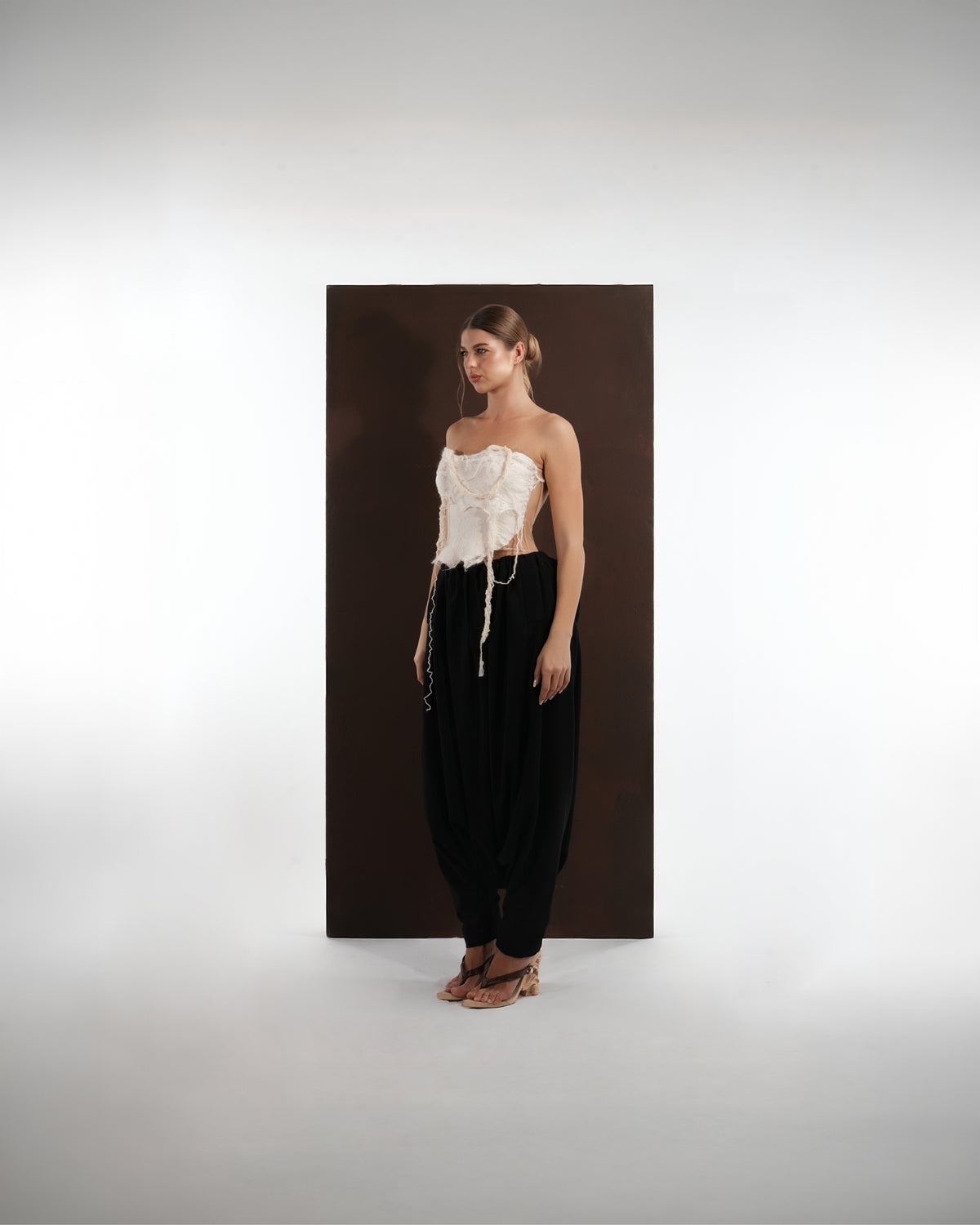 ALISADUDAJ black wool draped harem trousers, front three-quarter view showing low draped crotch