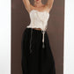 ALISADUDAJ black wool draped harem trousers, front view with arms raised showing waistband and drape