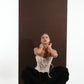ALISADUDAJ black wool draped harem trousers, crouching view showing spread drape and corset top