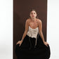ALISADUDAJ black wool draped harem trousers, crouching front view showing waist and draped legs