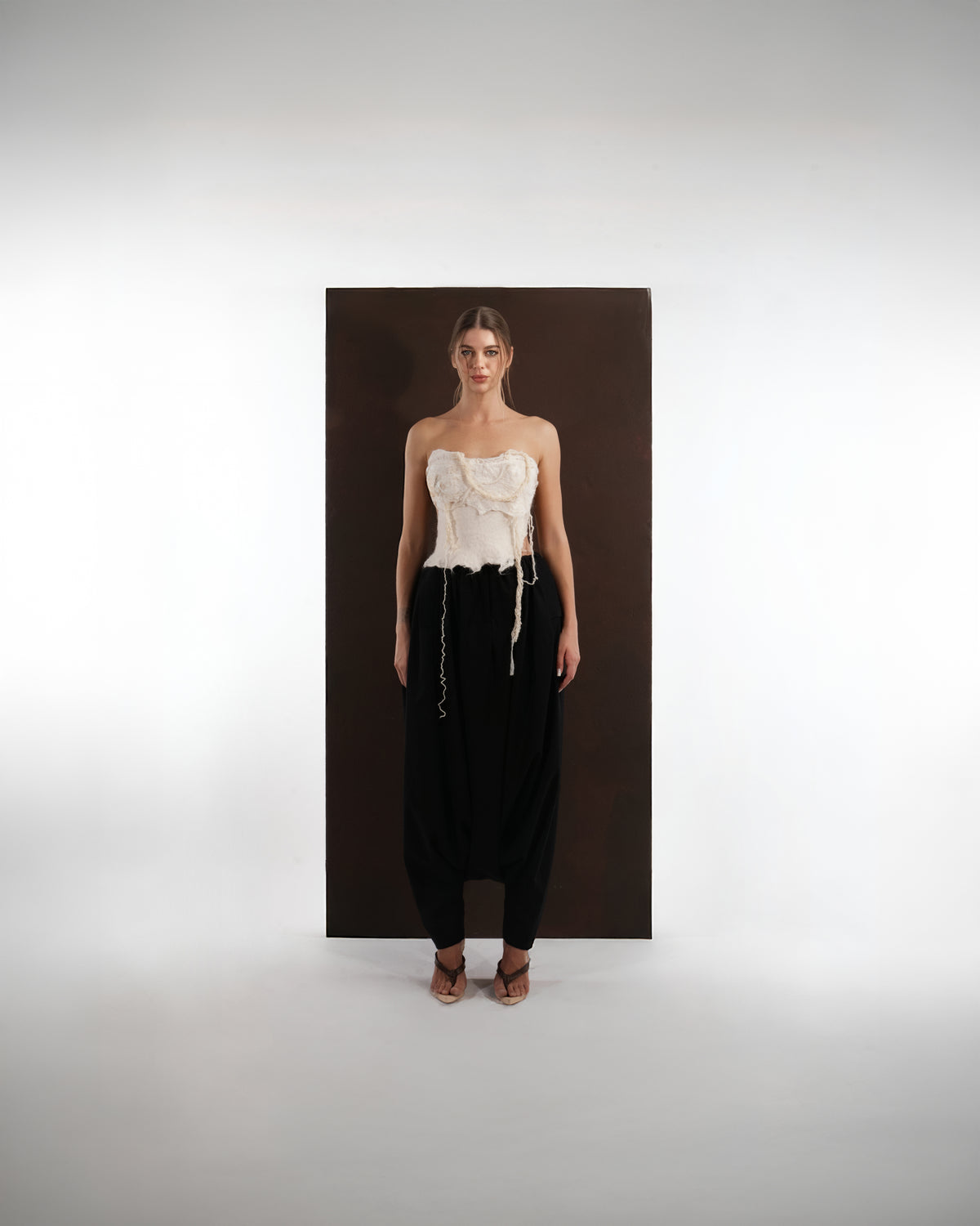 ALISADUDAJ black wool draped harem trousers, front view, full length, styled with an ivory felted corset top