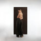 ALISADUDAJ black wool draped wide-leg trousers, back three-quarter view showing draped side panel, wool blend