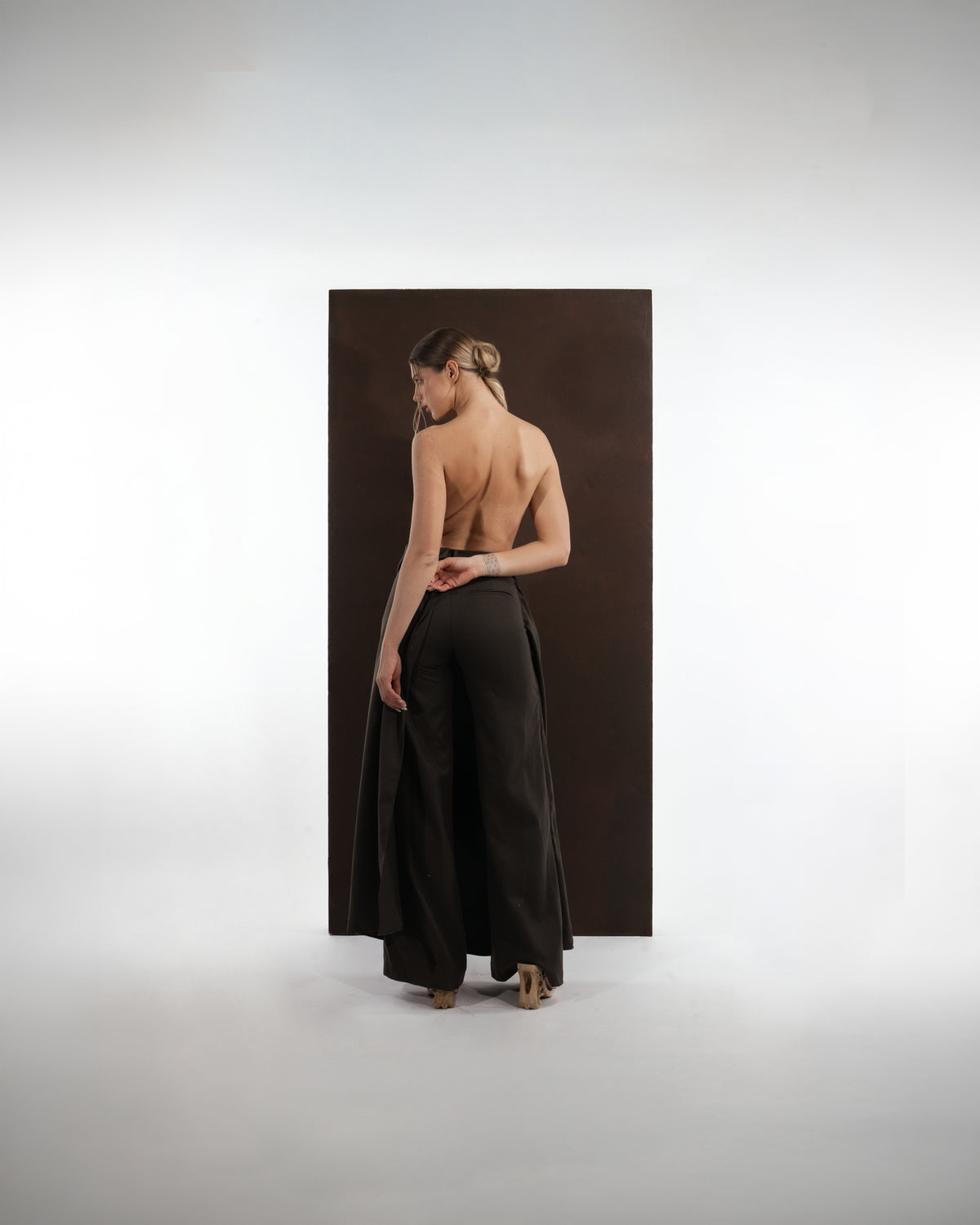 ALISADUDAJ black wool draped wide-leg trousers, back view showing high waistband and wide leg