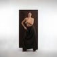 ALISADUDAJ black wool draped wide-leg trousers, three-quarter view with hand on hip showing draped panel