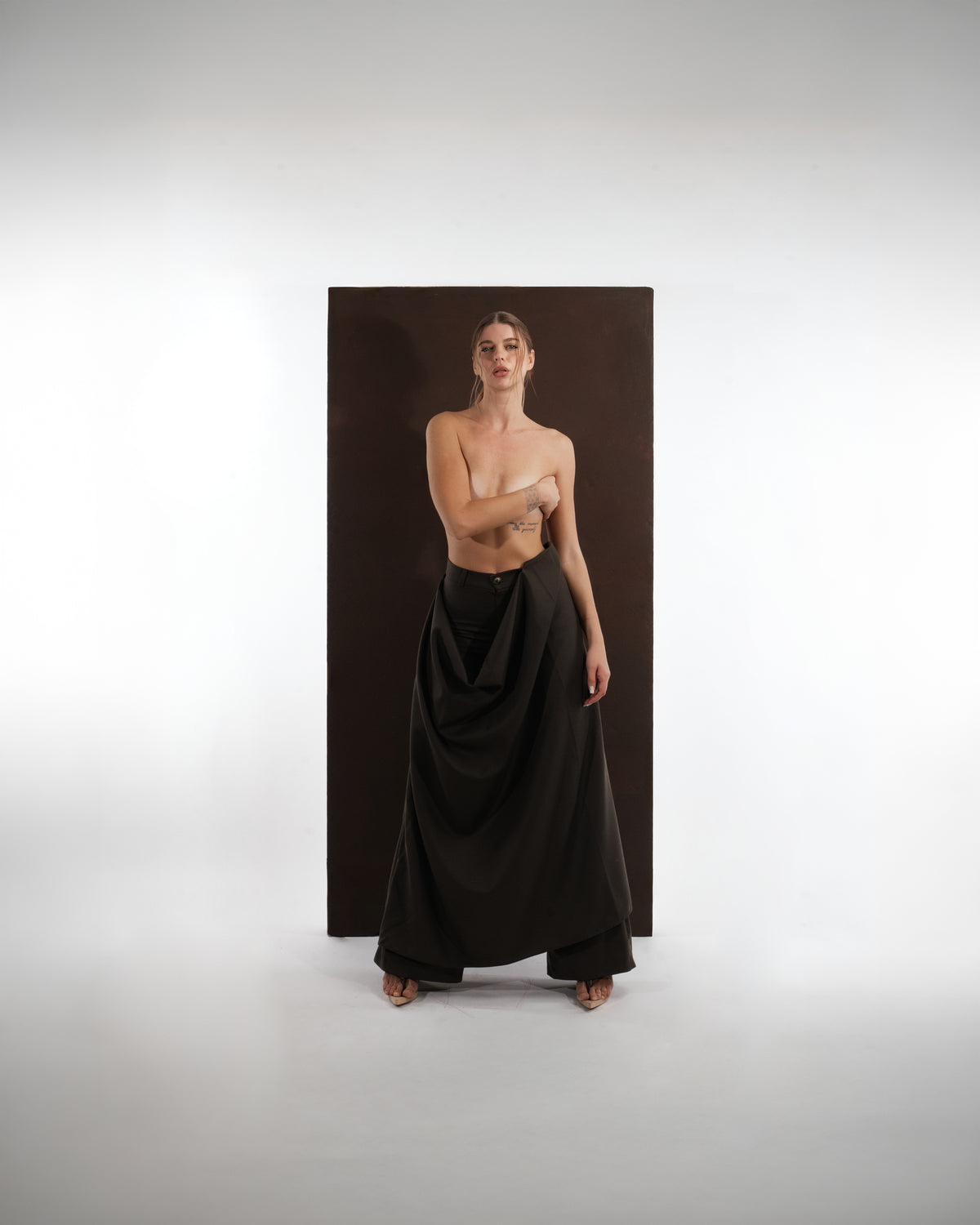 ALISADUDAJ black wool draped wide-leg trousers, front view styled without the top, showing waistband and draped overlay
