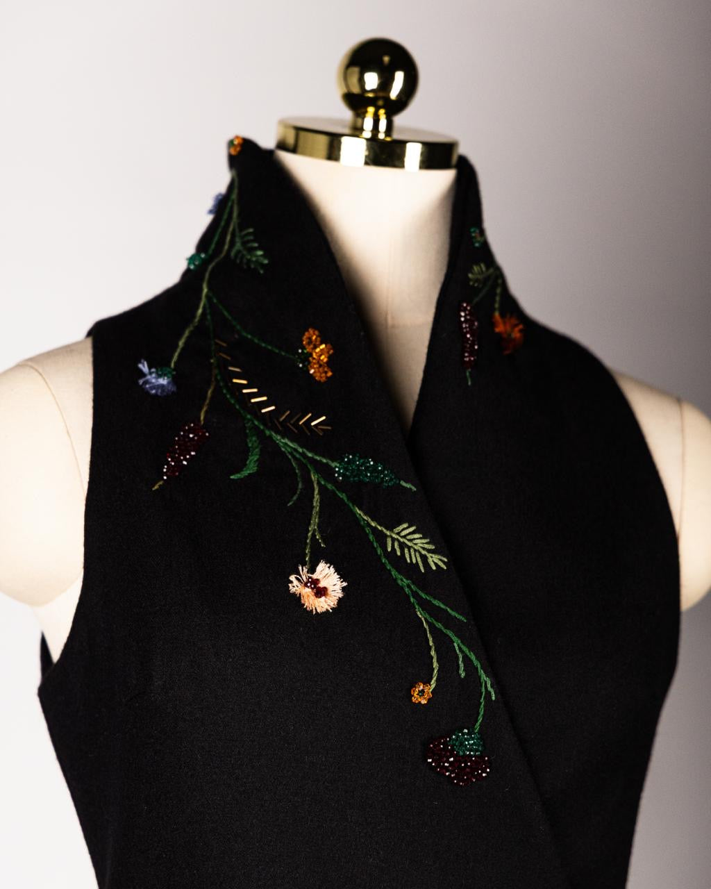ALISADUDAJ black wool hand-embroidered wrap dress, close-up of beaded floral embroidery on the wrap collar