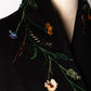 ALISADUDAJ black wool hand-embroidered wrap dress, close-up of hand-stitched flowers, leaves and glass beads, wool blend