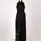 ALISADUDAJ black wool hand-embroidered wrap dress on a mannequin, front view, full length, showing floral embroidery at collar and hem