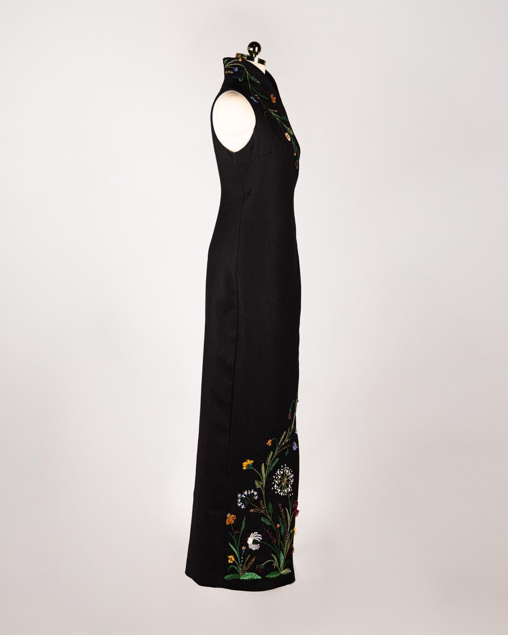 ALISADUDAJ black wool hand-embroidered wrap dress, side view showing wildflower embroidery along the side hem