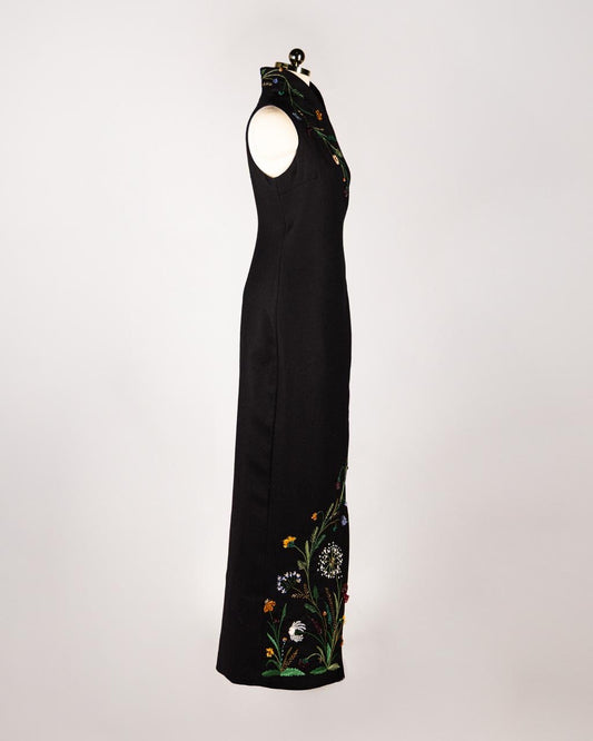 ALISADUDAJ black wool hand-embroidered wrap dress, side view showing wildflower embroidery along the side hem