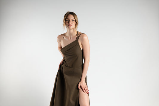 ALISADUDAJ brown cotton-twill one-shoulder midi dress, front three-quarter view showing draped asymmetric neckline and slit