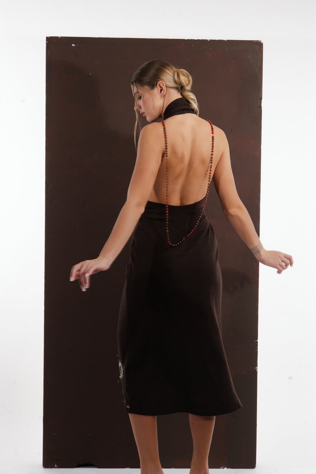 ALISADUDAJ brown wool garden-embroidered wrap dress, back view showing bare back and fitted midi skirt