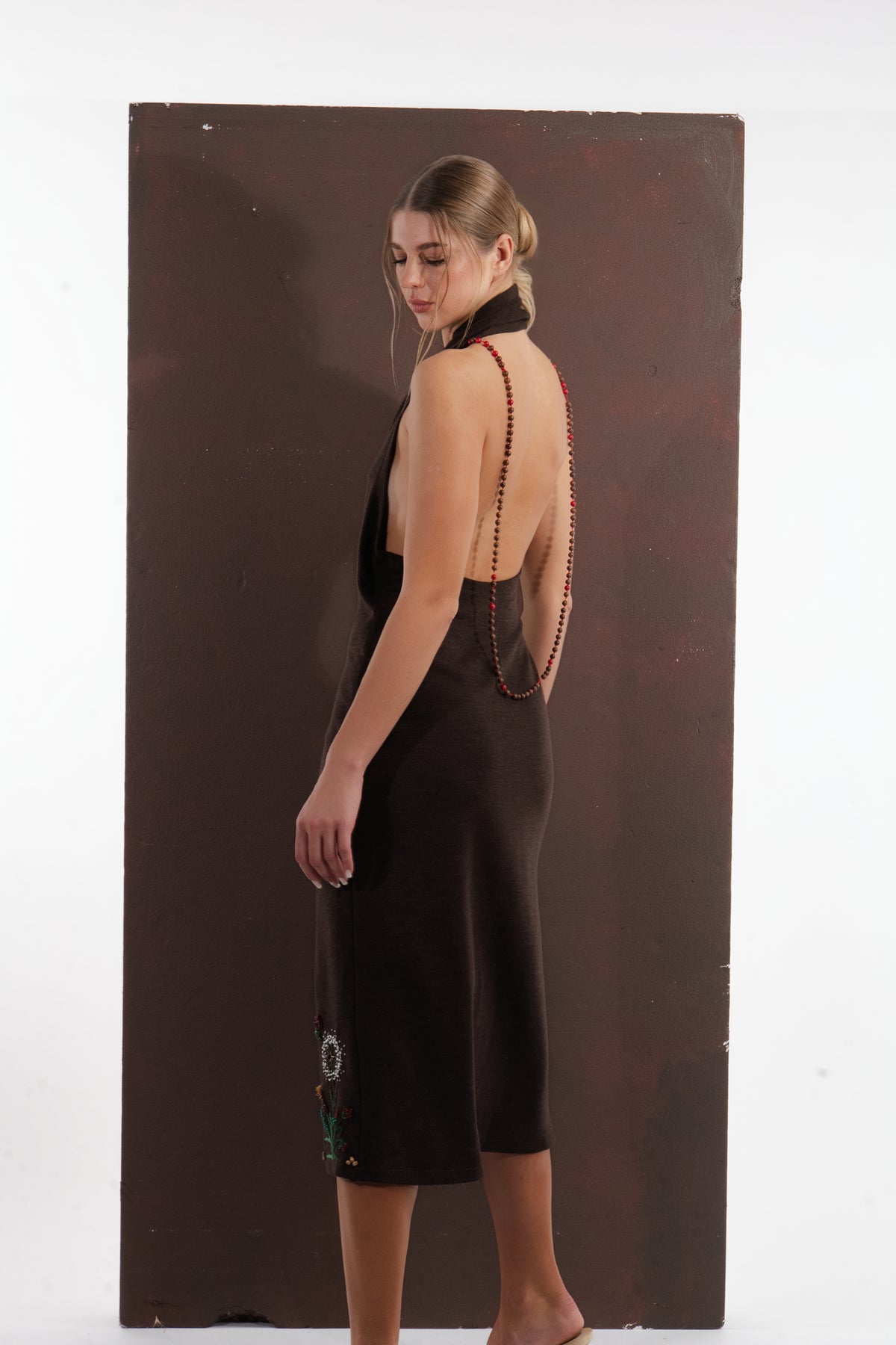 ALISADUDAJ brown wool garden-embroidered wrap dress, back three-quarter view showing beaded strap down the spine