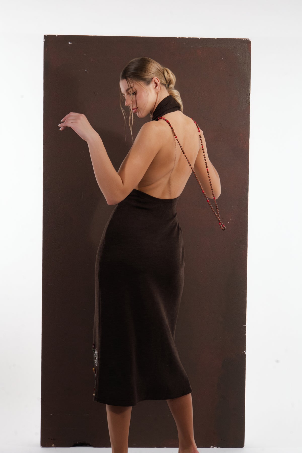 ALISADUDAJ brown wool garden-embroidered wrap dress, back view with arm raised showing beaded strap