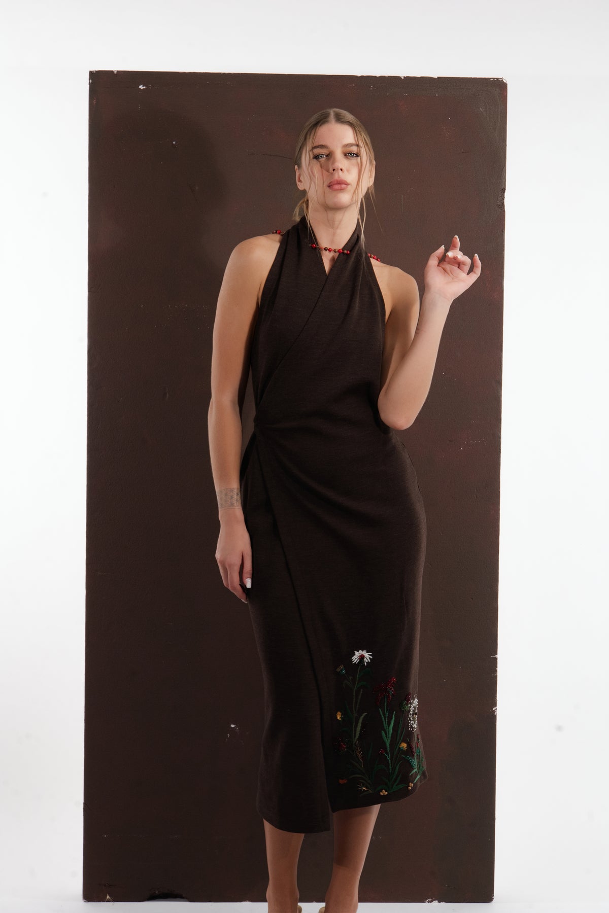 ALISADUDAJ brown wool garden-embroidered wrap dress, front view with hand raised showing halter neckline