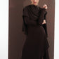 ALISADUDAJ brown wool open-back maxi dress, front three-quarter view with shawl and hand raised, showing slit