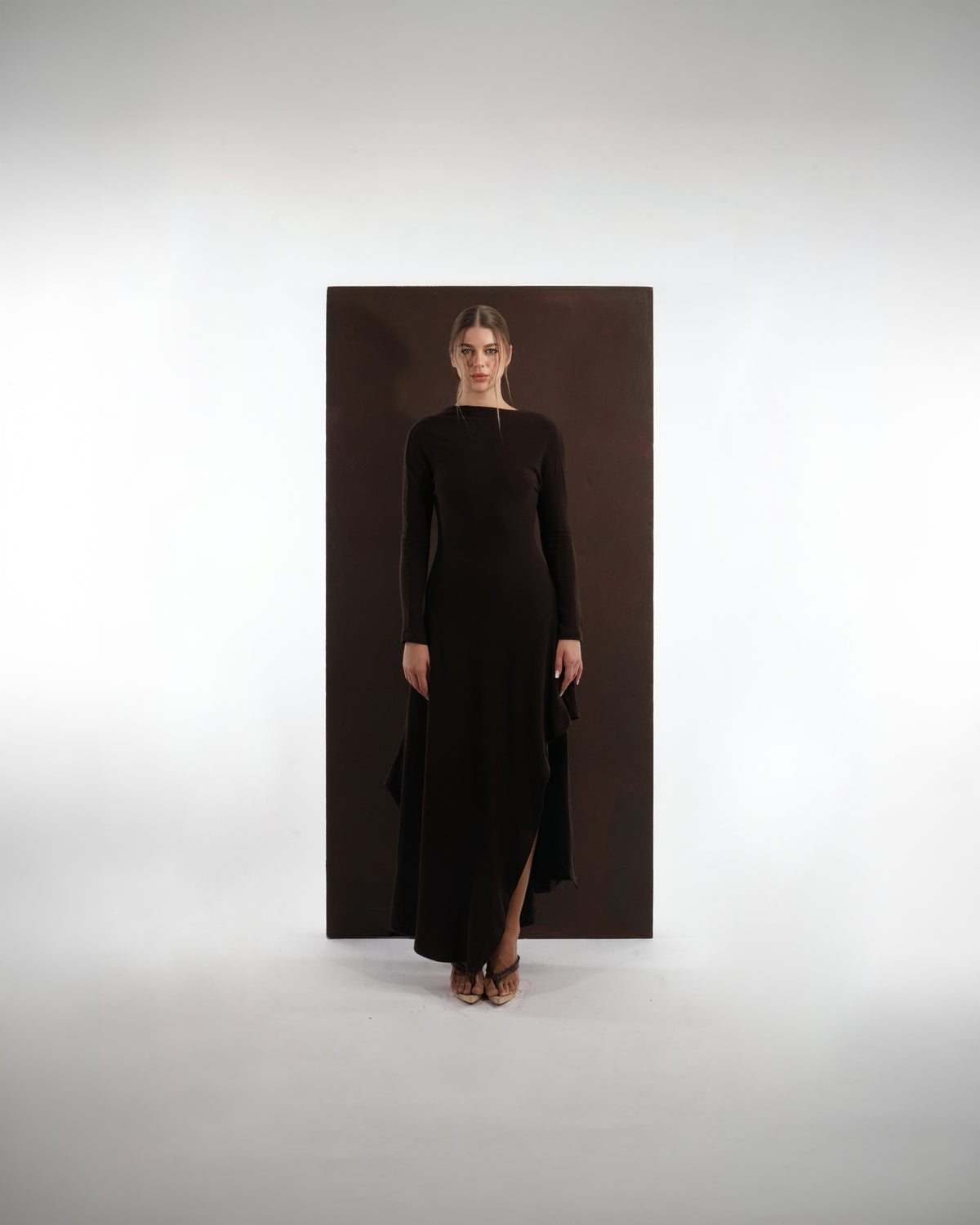 ALISADUDAJ brown wool open-back maxi dress, front view, full length, showing long sleeves and asymmetric slit hem