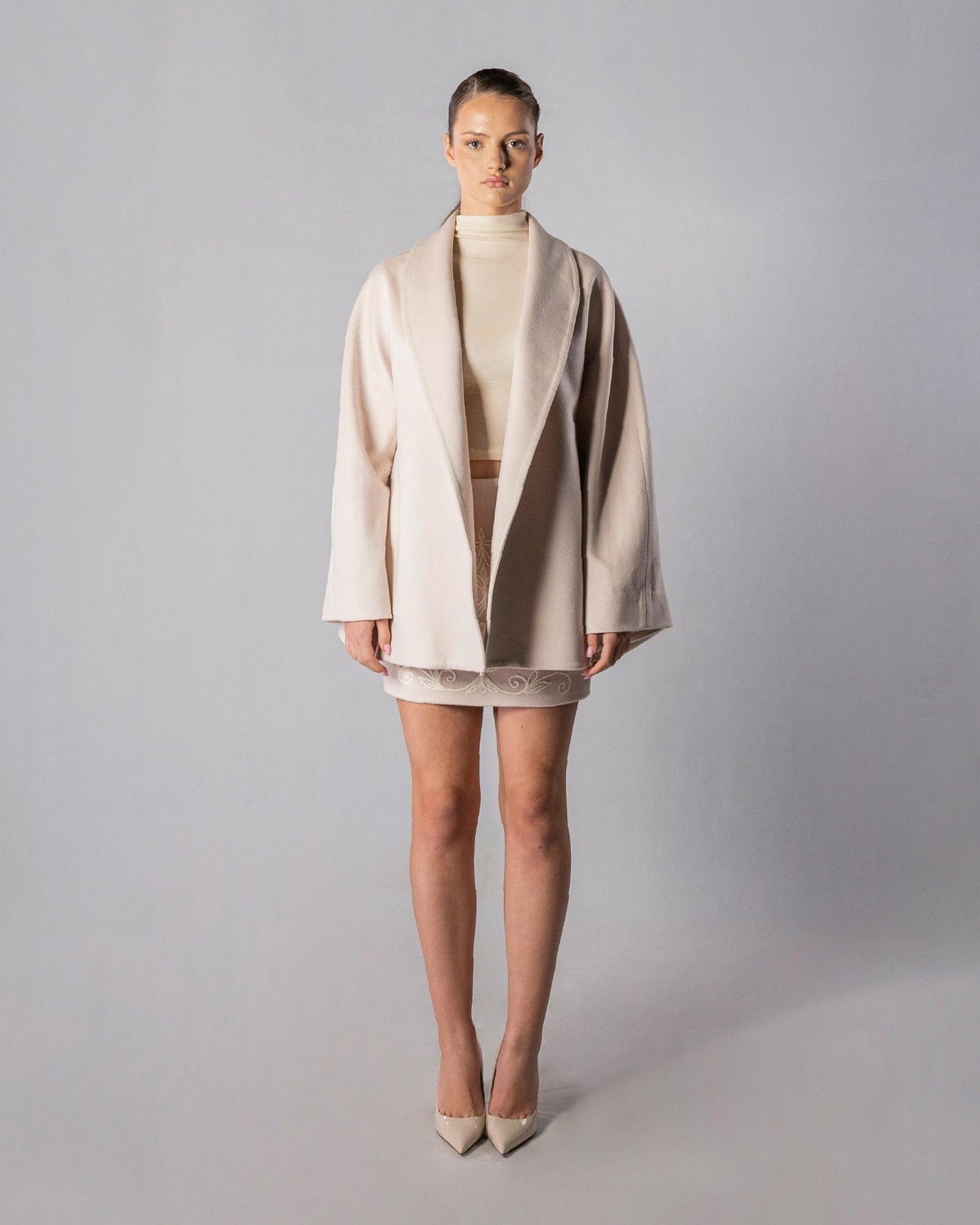 ALISADUDAJ CRAFT 01 beige cashmere coat, embroidered mini skirt and wool turtleneck set, front view, full length