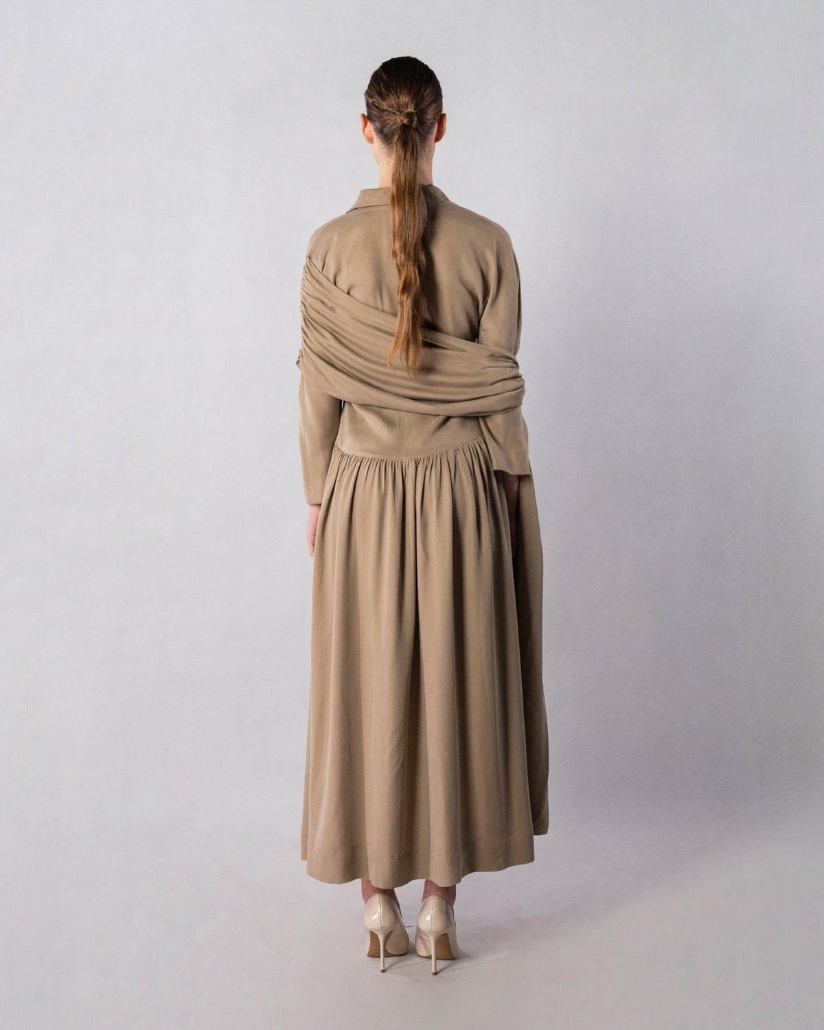 ALISADUDAJ CRAFT 02 brown cupro draped shirt dress, back view showing crossed drape and gathered skirt, cupro