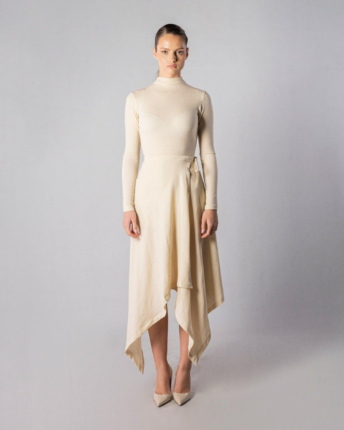 ALISADUDAJ CRAFT 07 off-white wool turtleneck and handkerchief-hem wrap skirt set, front view, full length