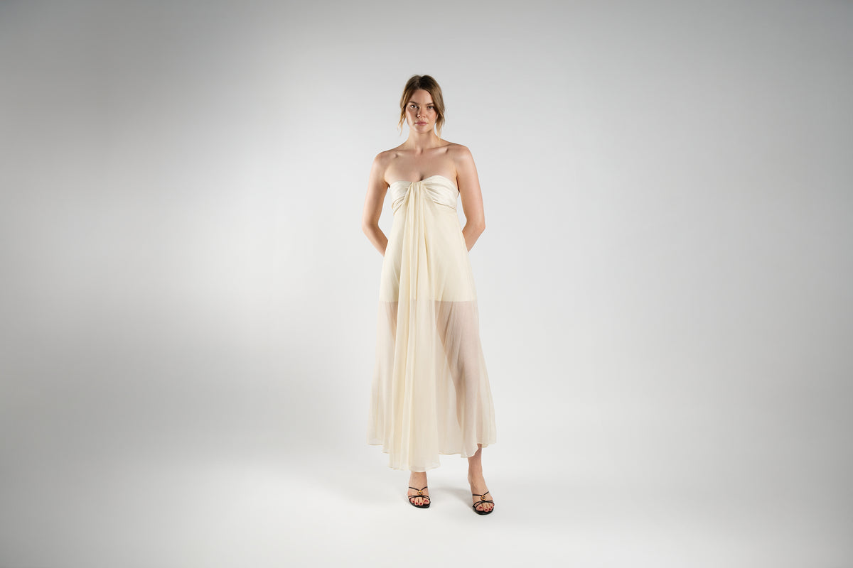 ALISADUDAJ cream linen and silk strapless maxi dress, front view, full length, showing knotted bust and sheer skirt