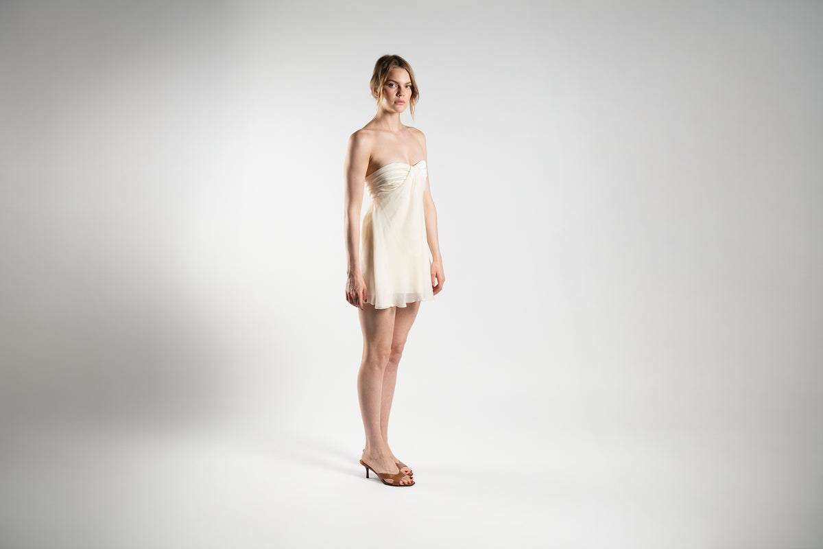 ALISADUDAJ cream linen and silk strapless mini dress, side view showing sweetheart neckline and sheer hem, linen and silk